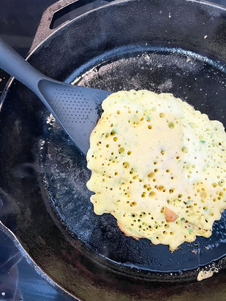 Vegan Omelette with Chickpea Flour Cooking in cast iron pan