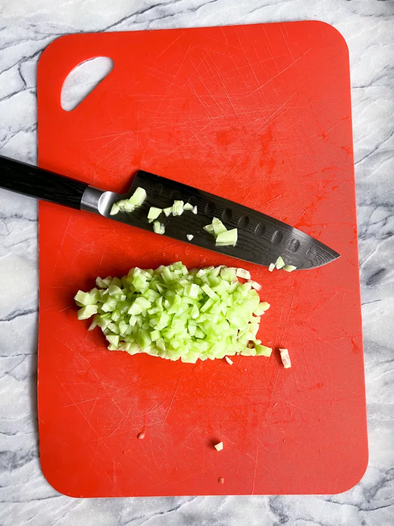 cucumber cut up on red cutting board with Shun Knife