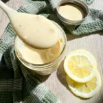 lemon dressing sauce on spoon with lemon slices