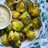 smashed brussels on a plate with dip