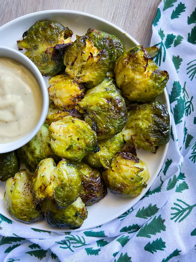 smashed brussels on a plate with dip