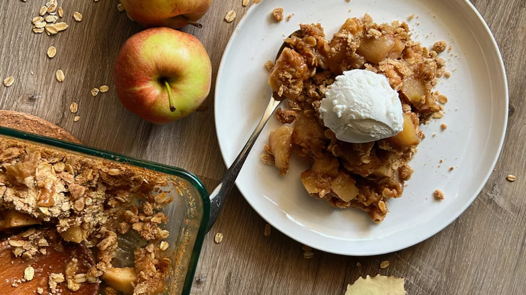 vegan-apple-crisp-on-white-plate-with-ice-cream