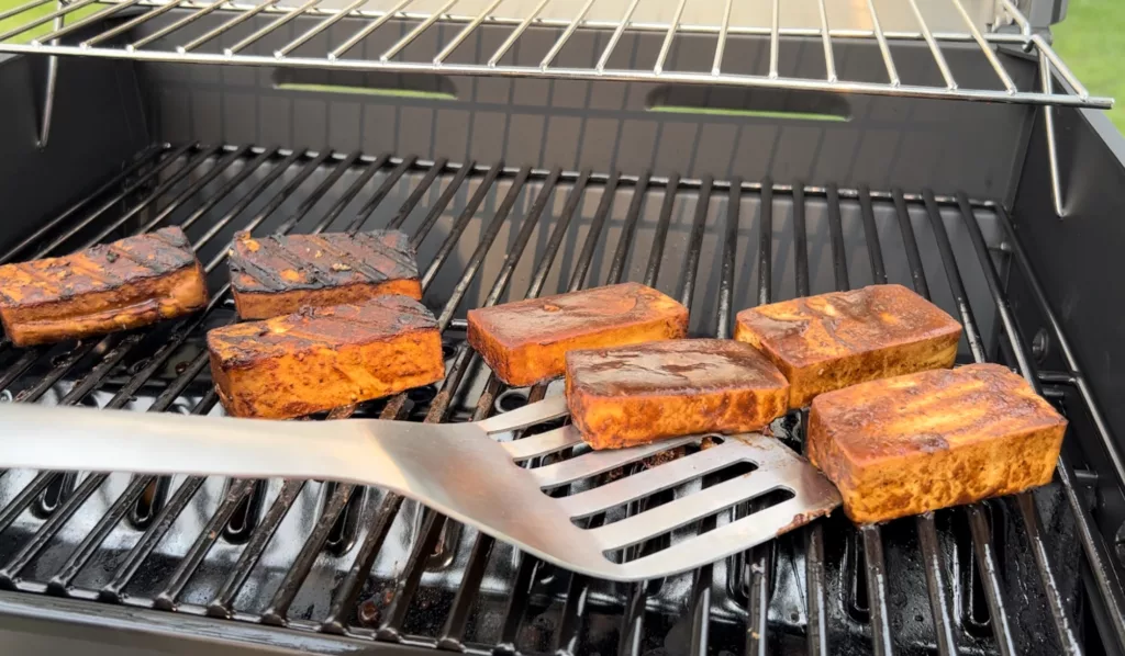 tofu steaks on grill with flipper