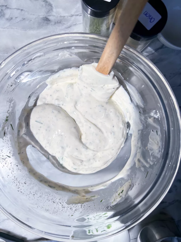 thick creamy vegan ranch dip in glass mixing bowl