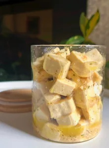 tofu feta cheese in glass container