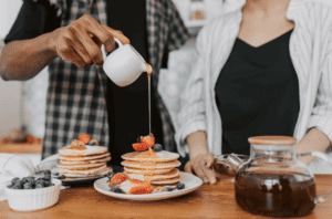 maple-syrup-being-poured-on-pancakes