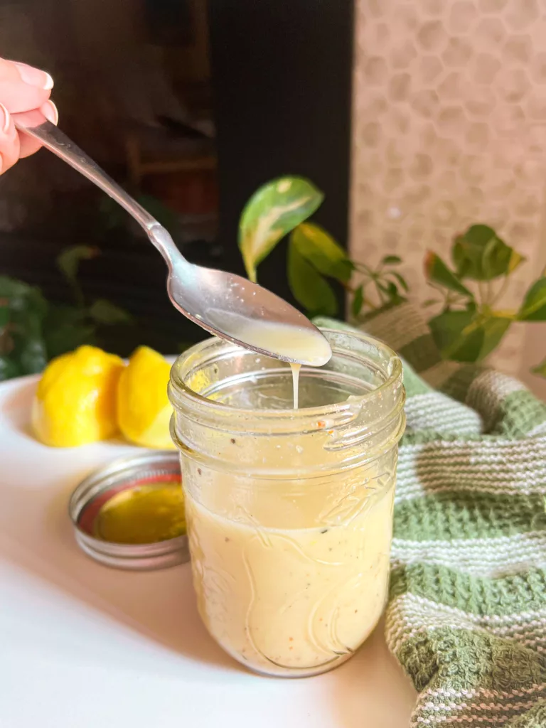 Lemon vinaigrette dressing with spoon