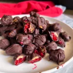 chocolate covered frozen raspberries on plate