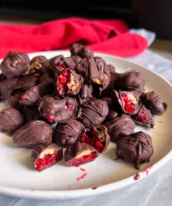 chocolate covered frozen raspberries on plate