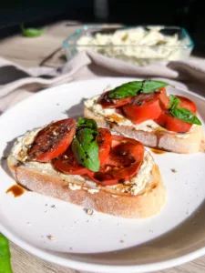 Sourdough bread sliced with cream cheese tomato basil and balsamic reduction