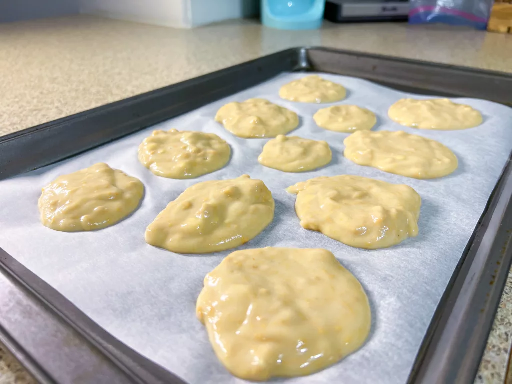 peanut butter yogurt mixture spooned on baking sheet