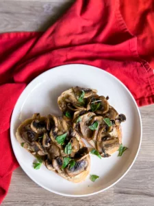 mushrooms on toast with vegan cream cheese on plate