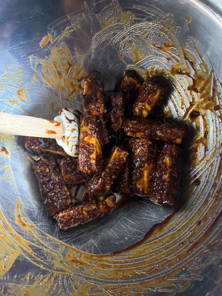 Vegan BBQ Wings strips in mixing bowl