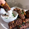 Vegan Tofu BBQ wings dipped in vegan ranch