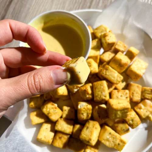 hand holding baked tofu bites