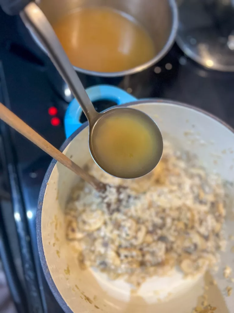 vegan mushroom risotto adding veggie broth