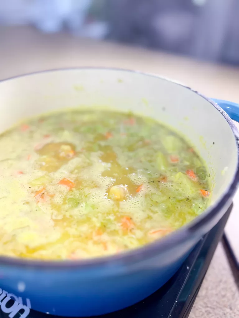 red lentil potato soup boiling in pot