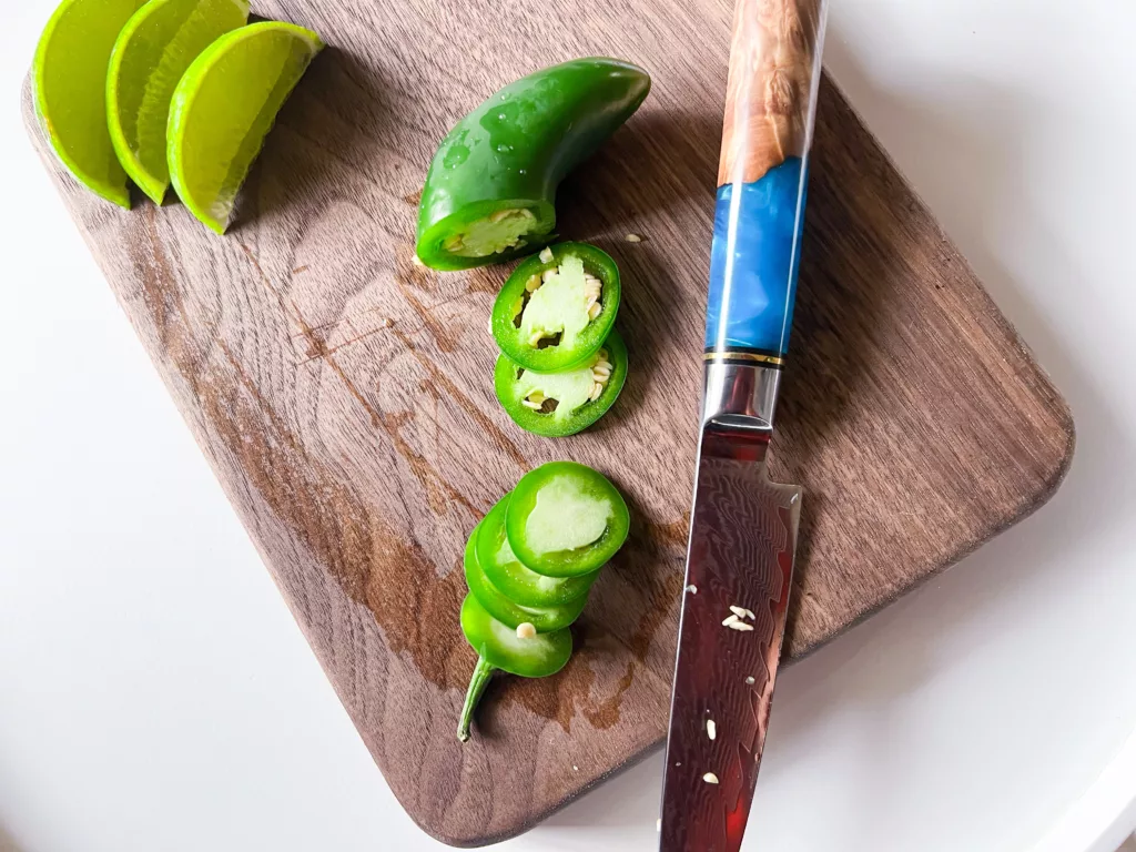 santoku knives and essy cooks jalapeno on wood cutting board