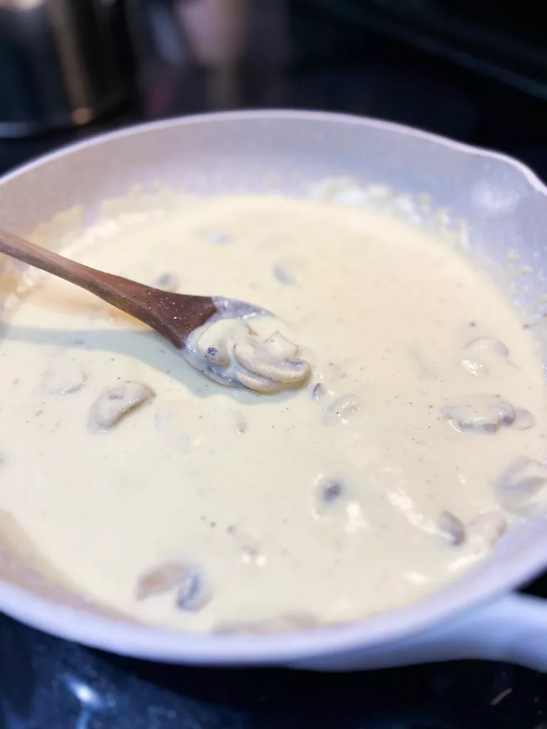 vegan alfredo sauce in pan with mushrooms