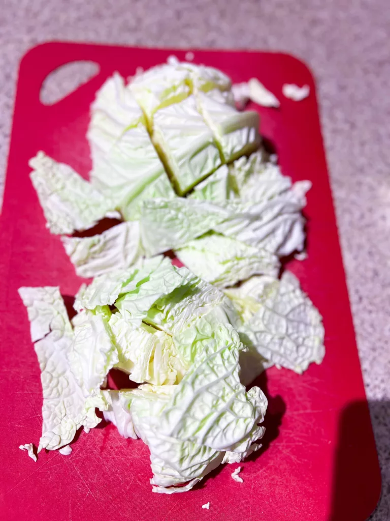 Taiwanese cabbage on red cutting board