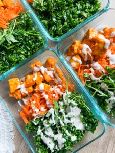baked tofu bites with buffalo sauce and kale meal prep