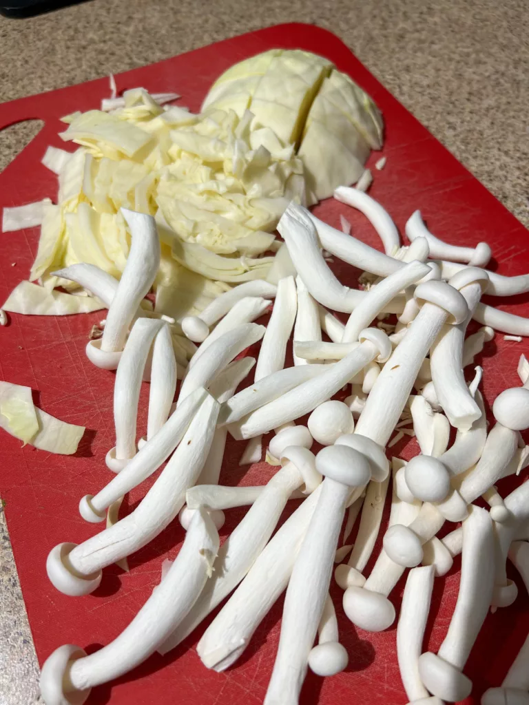 mushrooms and cabbage on red cutting board