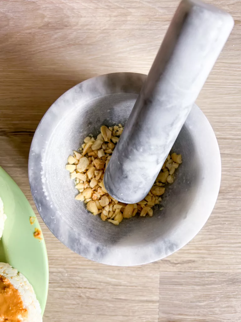 crushing peanuts in pestle