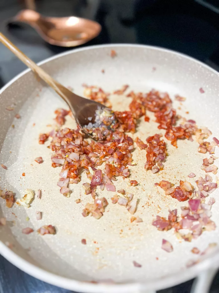 cooked garlic and onion in frying pan