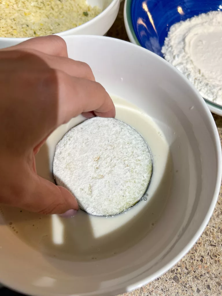 dipping eggplant into plant milk