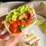 vegan burrito in hand