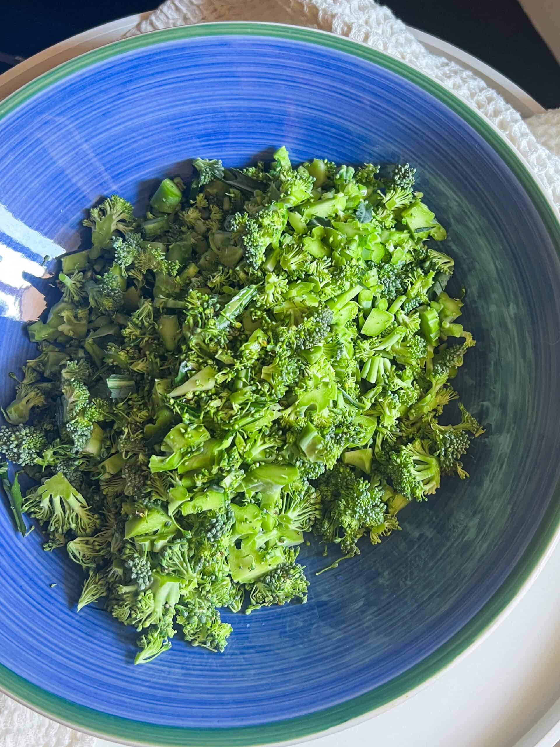 cut up broccoli in blue bowl