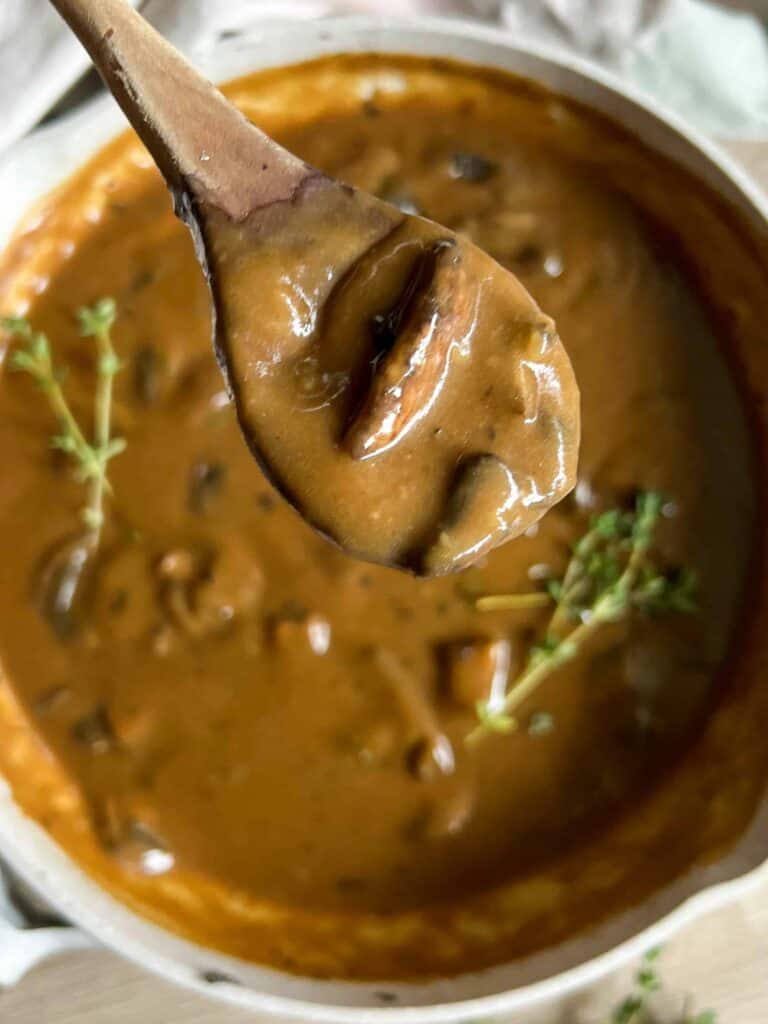 vegan mushroom gravy recipe on wooden spoon