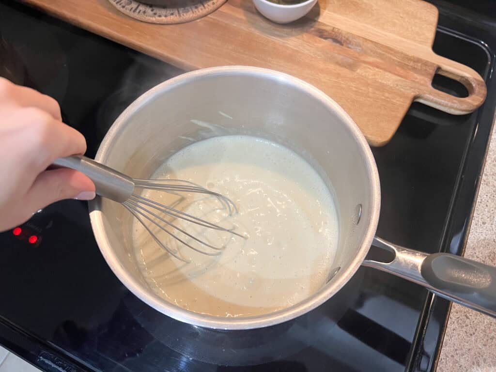 mixing the vegan cheese in pot for fondue