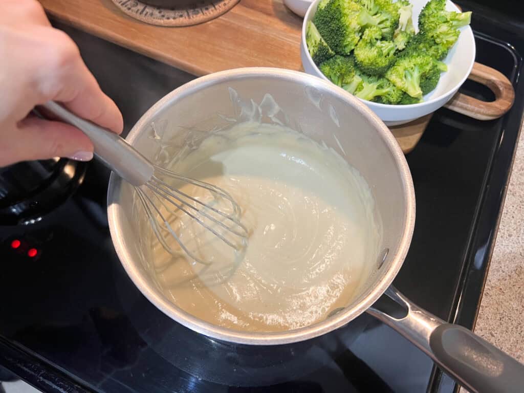 stirring the vegan cheese fondue