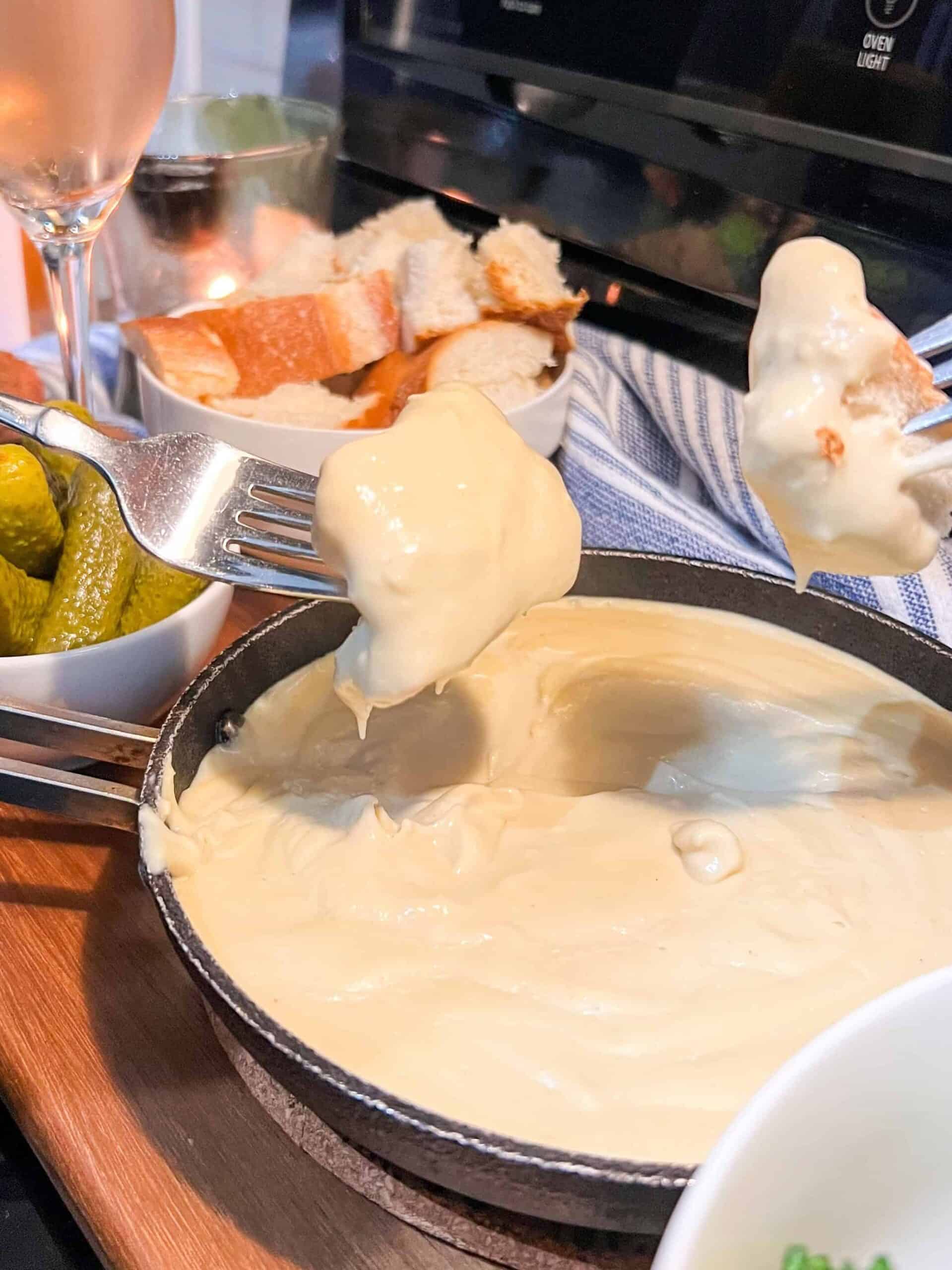 bread dipping into vegan cheese fondue