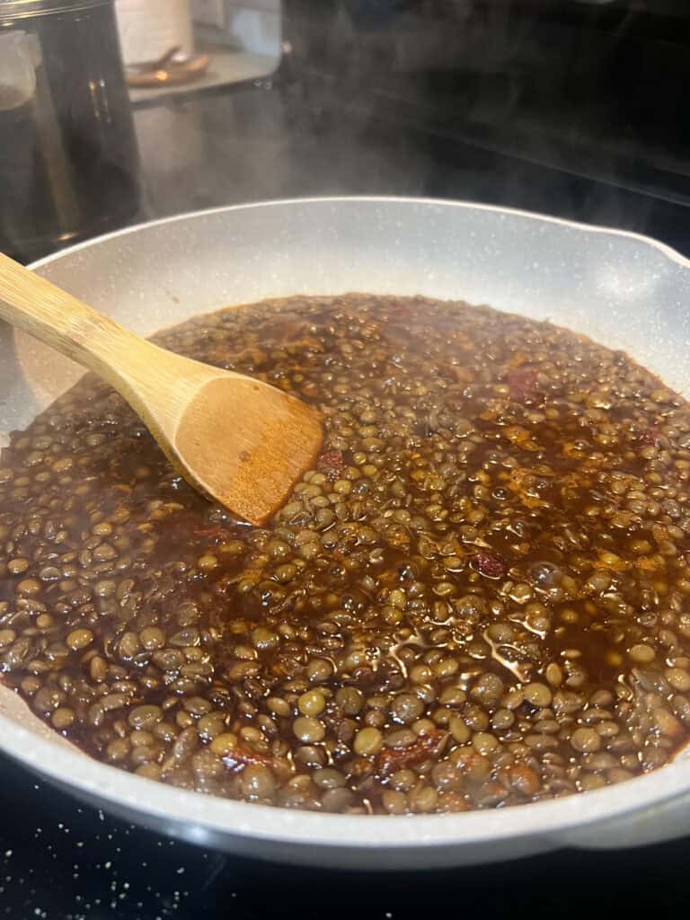 lentils cooking in light grey pan