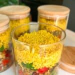 Three jars with food in them on a table