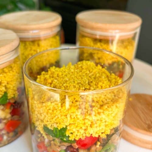Three jars with food in them on a table