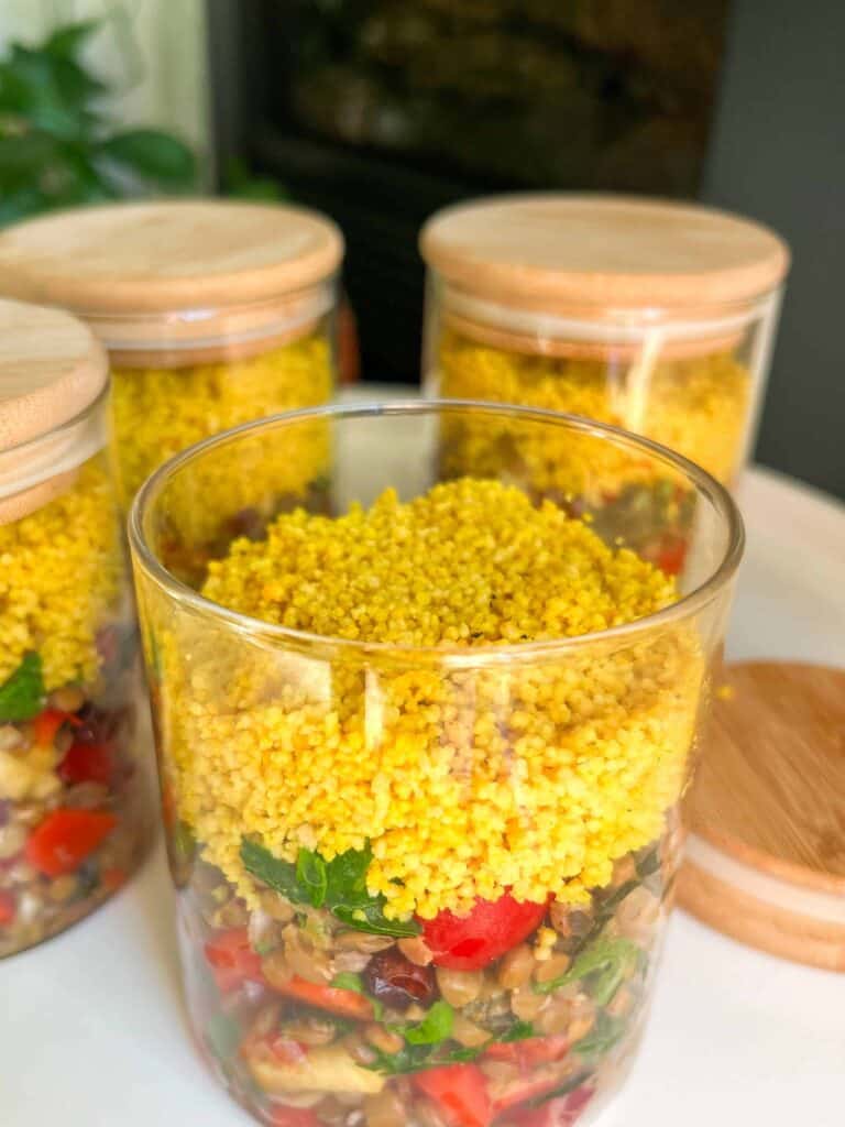 Three jars with food in them on a table