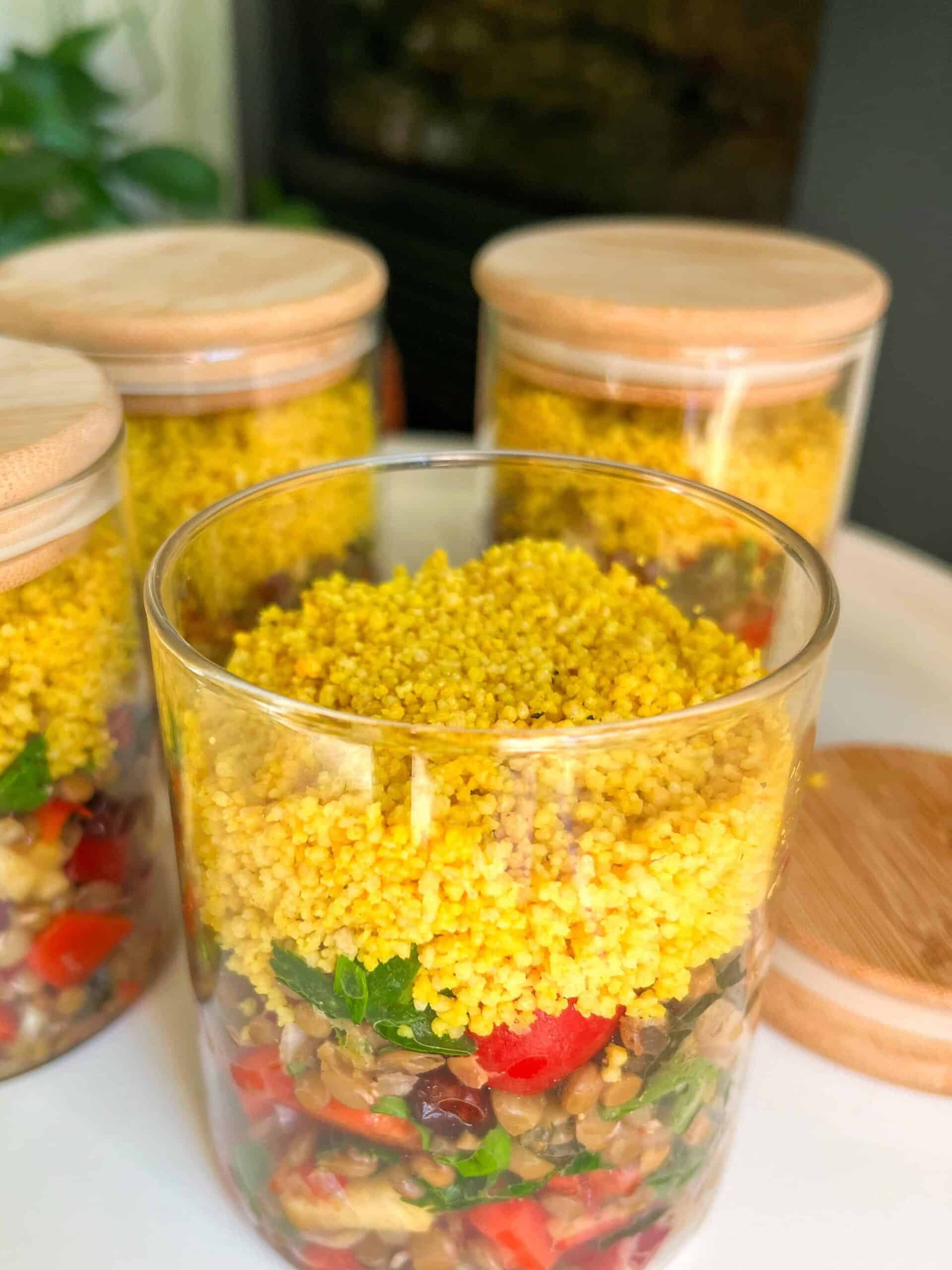 Three jars with food in them on a table
