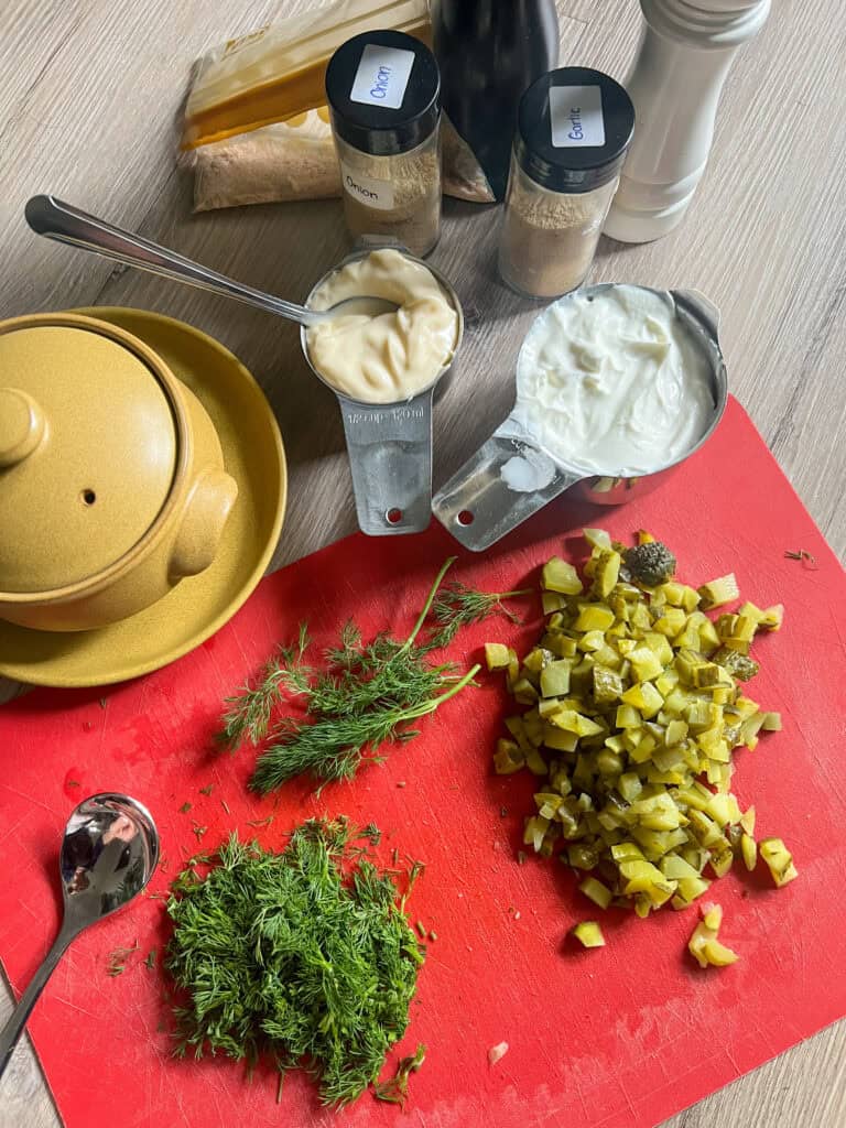 A red cutting board with various ingredients on it.