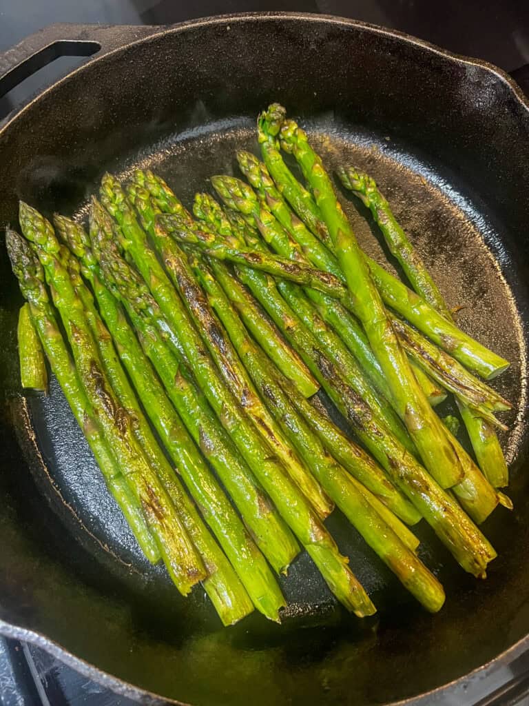 Asparagus grilling on cast iron pan