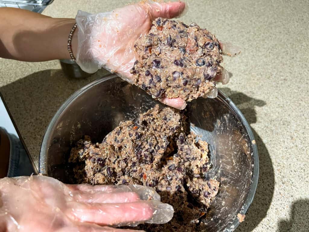 Quinoa Black Bean Burgers uncooked patty mixture in hands