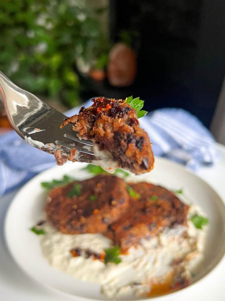 Quinoa Black Bean Burgers on fork white plate in background