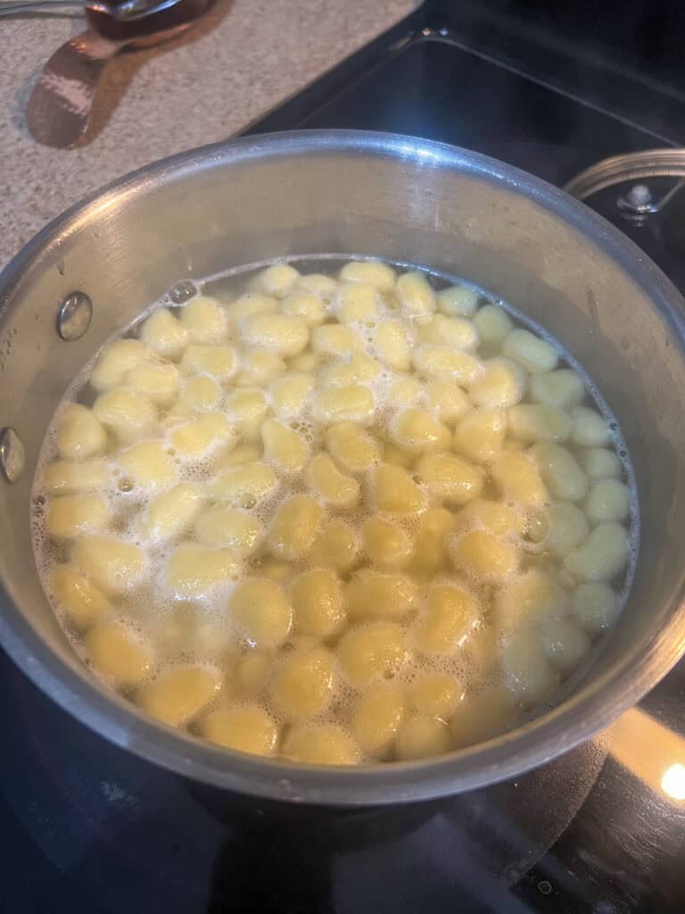 Gnocchi cooking in stainless steel pot
