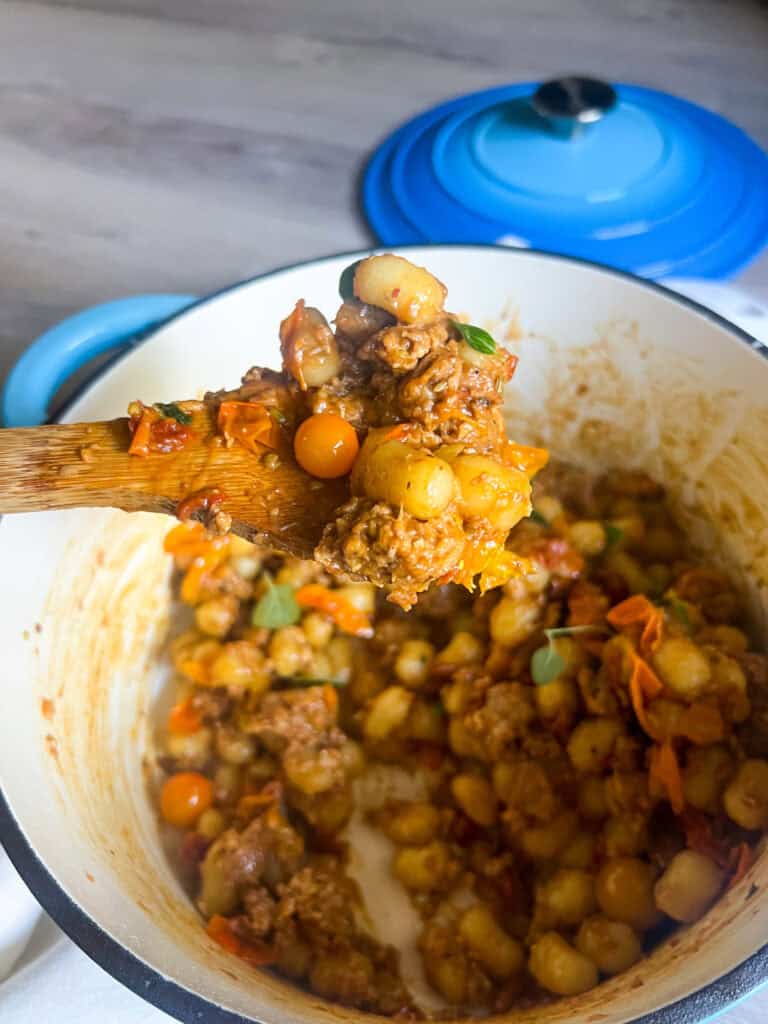 Cherry Tomato & Sun-Dried Tomato Gnocchi (with Vegetarian Sausage) on wooden spoon