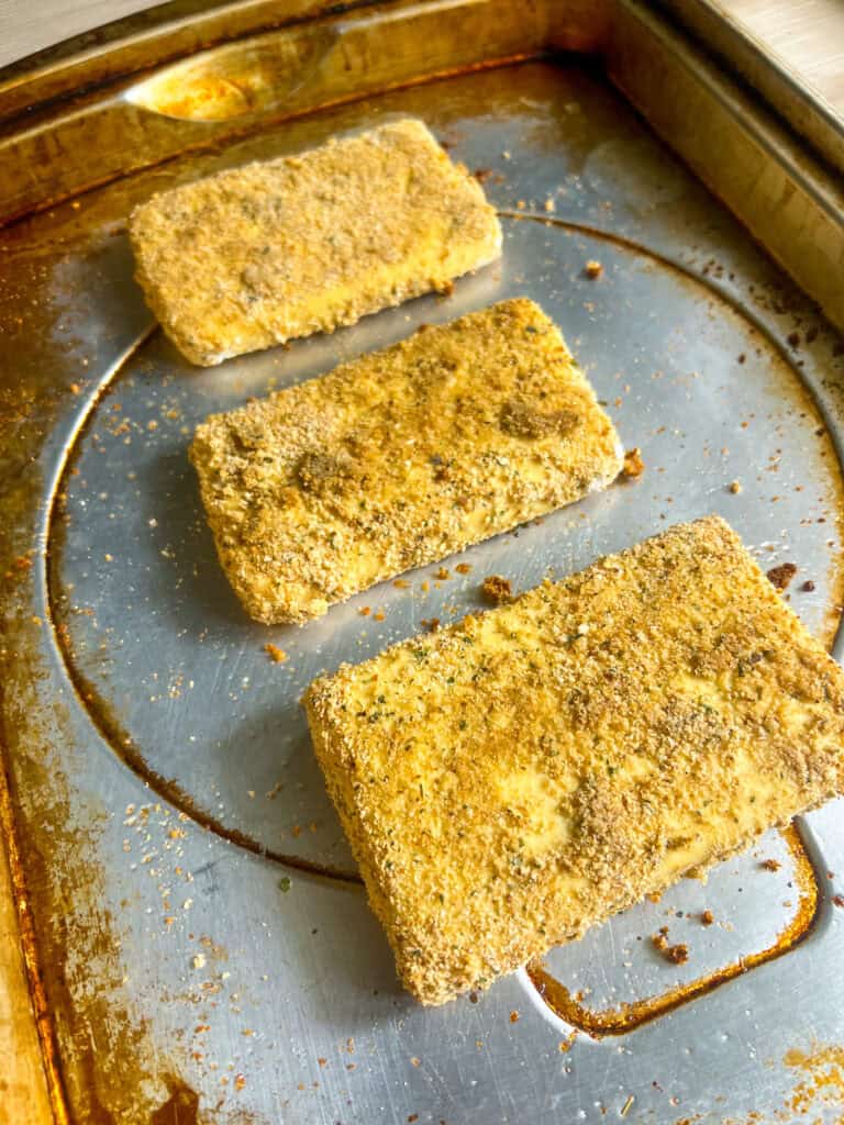 baked breaded tofu steaks on baking sheet