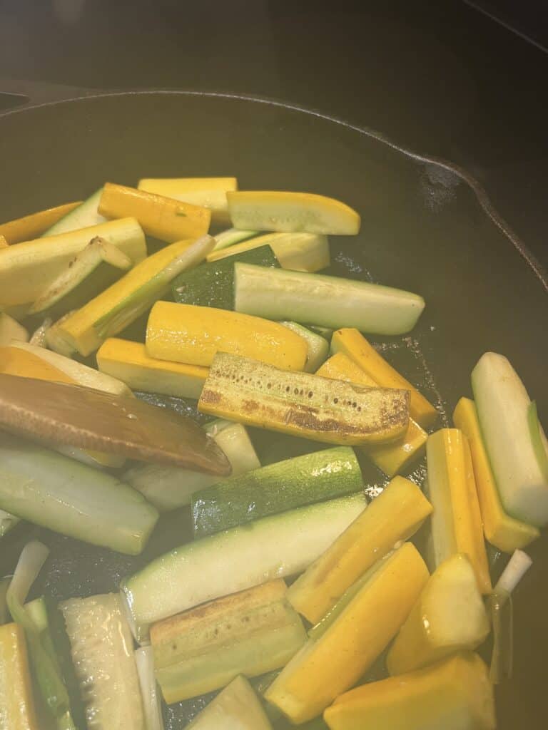 crispy Zucchini with Onions cooking in cast iron frying pan