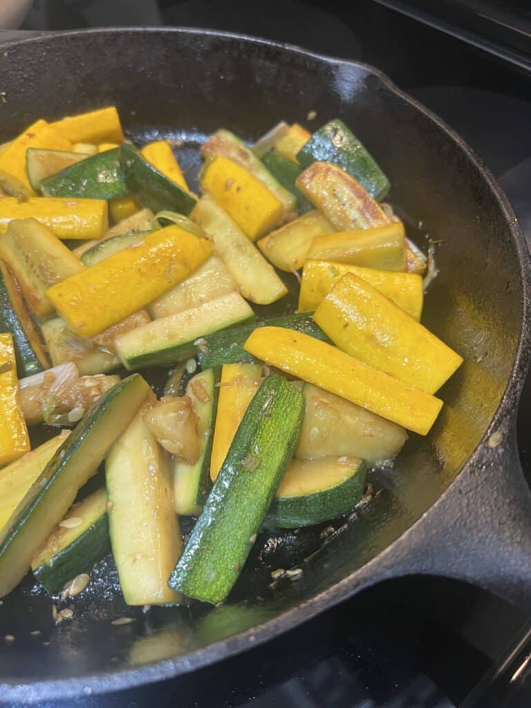 Zucchini with Onions cooking in cast iron frying pan