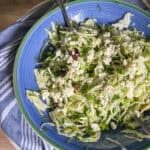 greek cabbage salad in large blue bowl